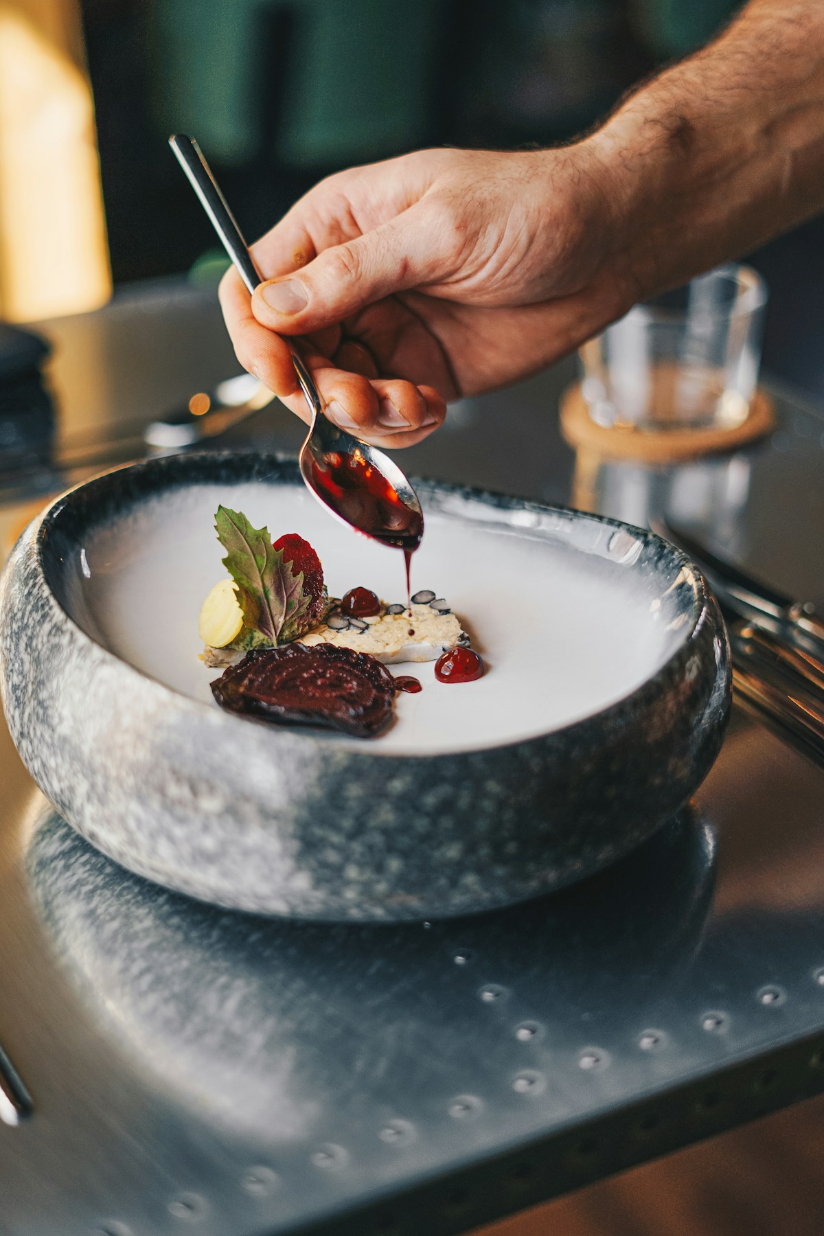 Chef carefully finishing a plated dish